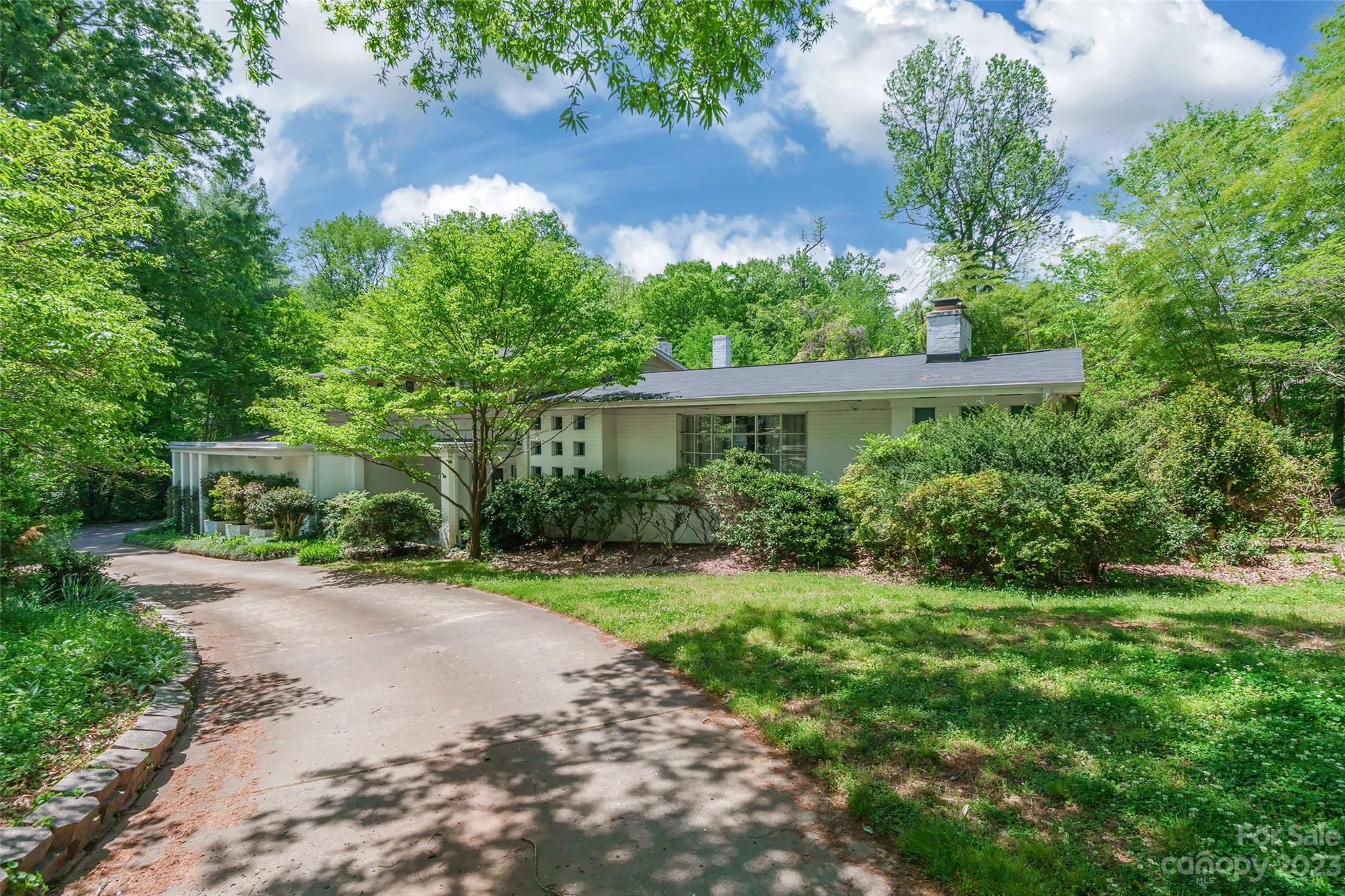 6916 Thermal Road Charlotte, NC 28211 - Photo 2 of 47 a front view of a house with a yard and a garden