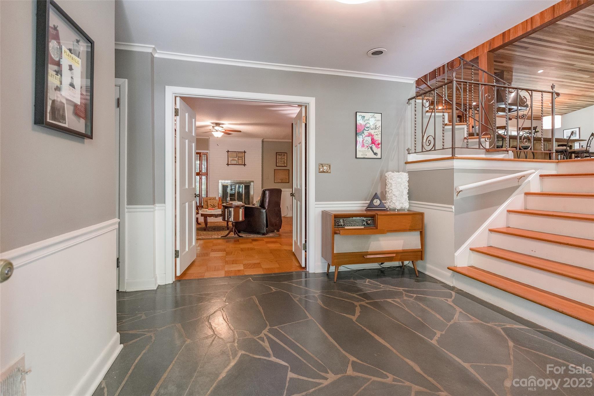 6916 Thermal Road Charlotte, NC 28211 - Photo 4 of 47 a view of a hallway with a tv and couches next to a large window
