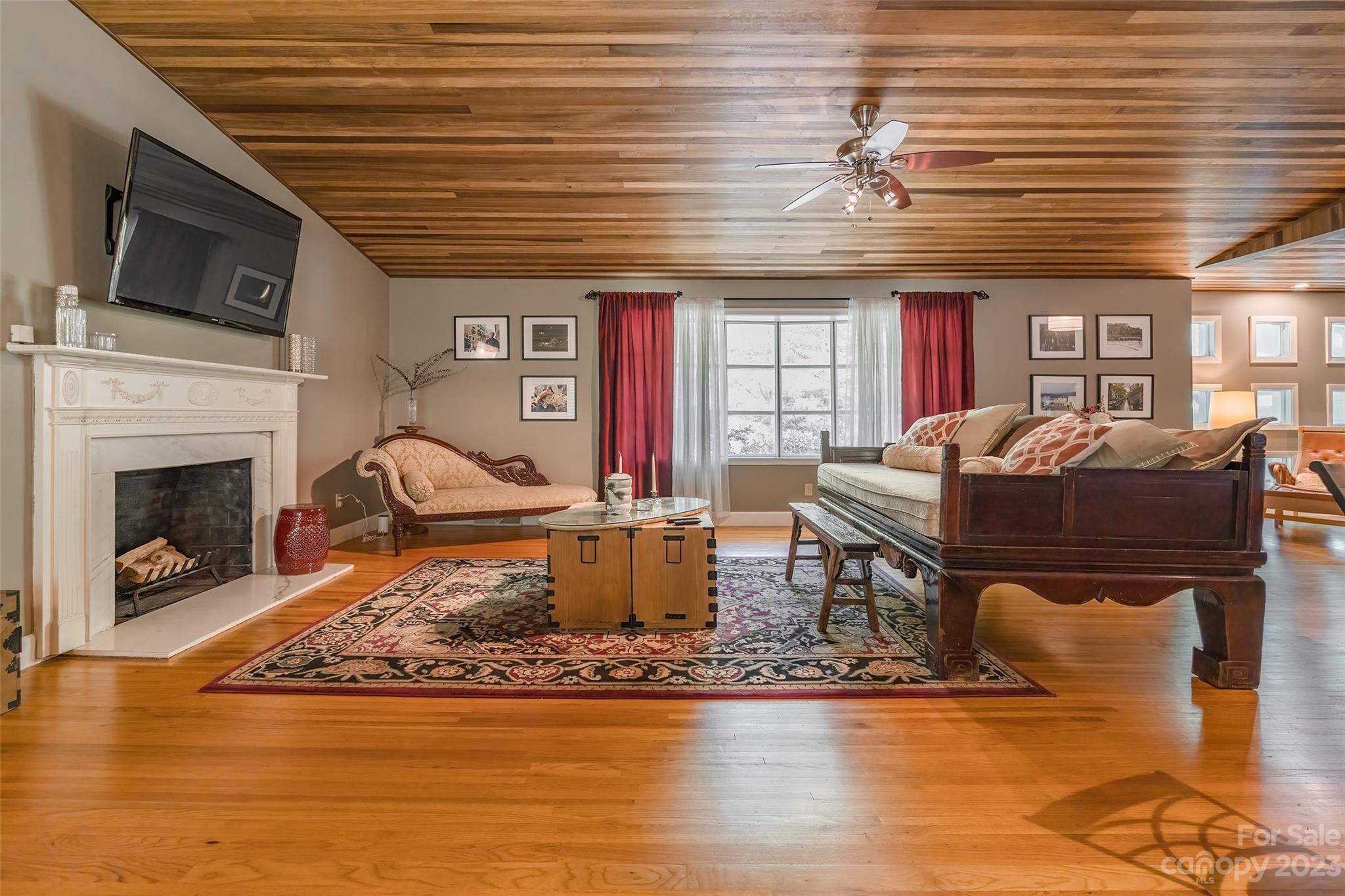 6916 Thermal Road Charlotte, NC 28211 - Photo 7 of 47 a living room with furniture a flat screen tv and a fireplace