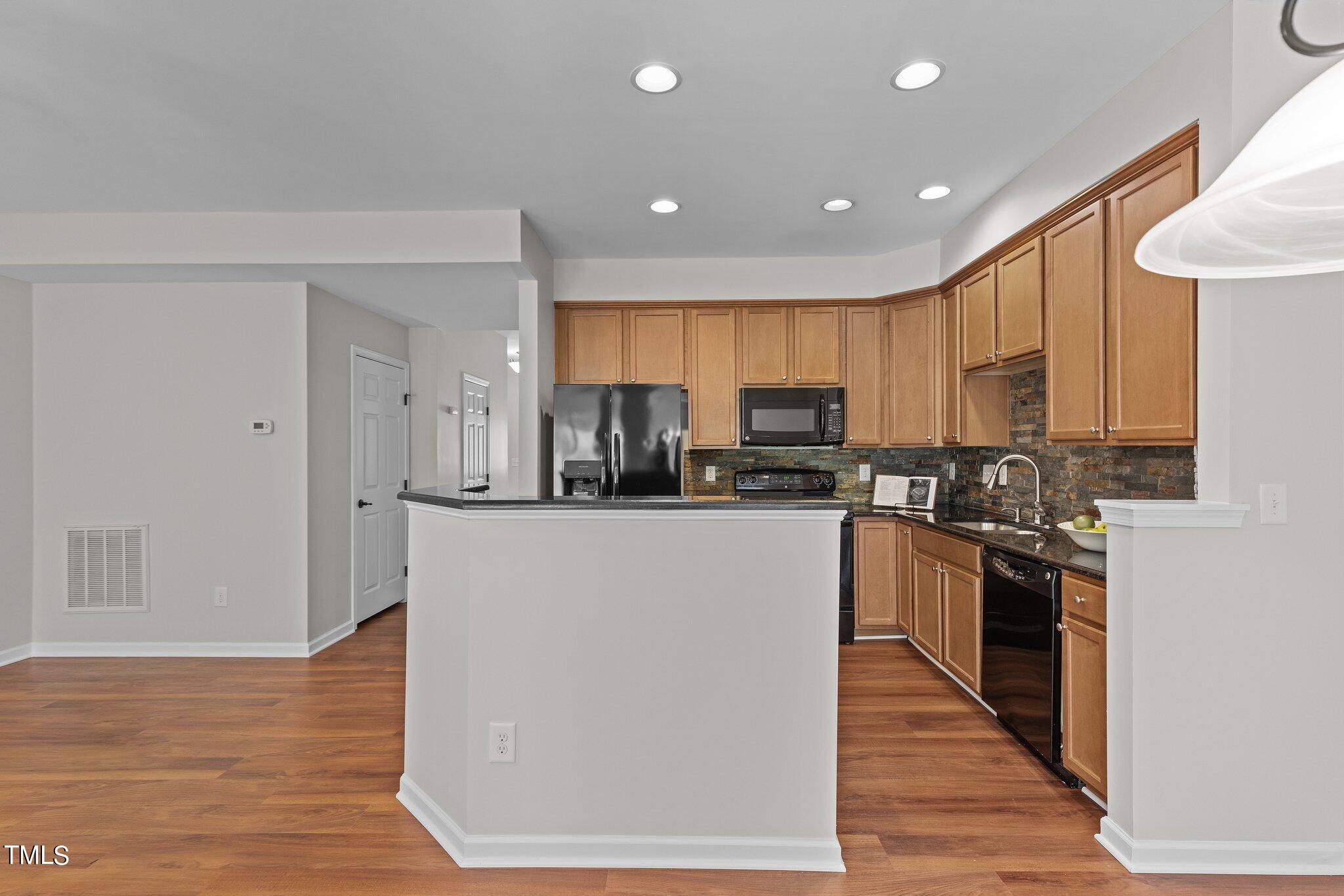 439 Panorama View Loop Cary, NC 27519 - Photo 11 of 42 a kitchen with stainless steel appliances granite countertop a refrigerator stove top oven and sink