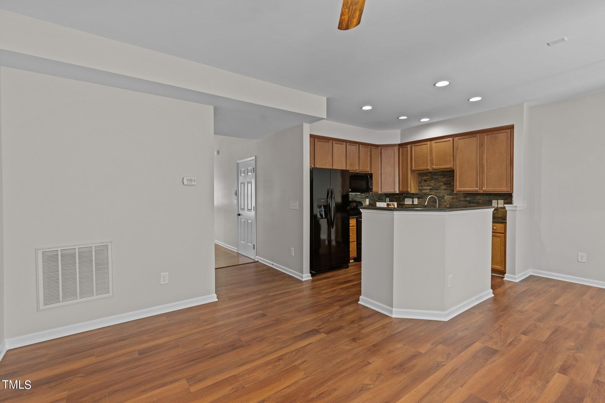 439 Panorama View Loop Cary, NC 27519 - Photo 13 of 42 a view of kitchen with stainless steel appliances granite countertop cabinets and wooden floor