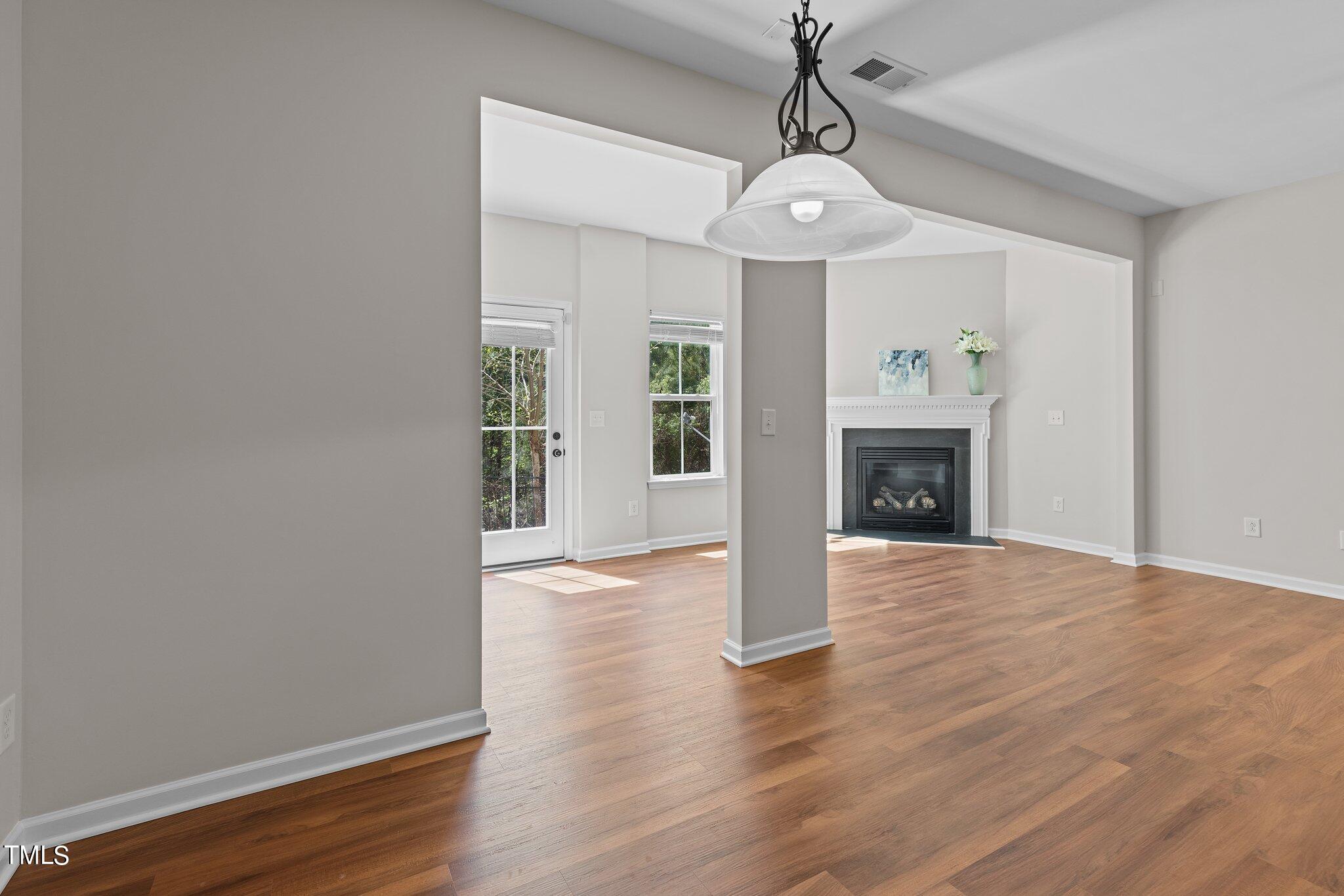 439 Panorama View Loop Cary, NC 27519 - Photo 17 of 42 a view of an empty room with wooden floor fireplace and a window