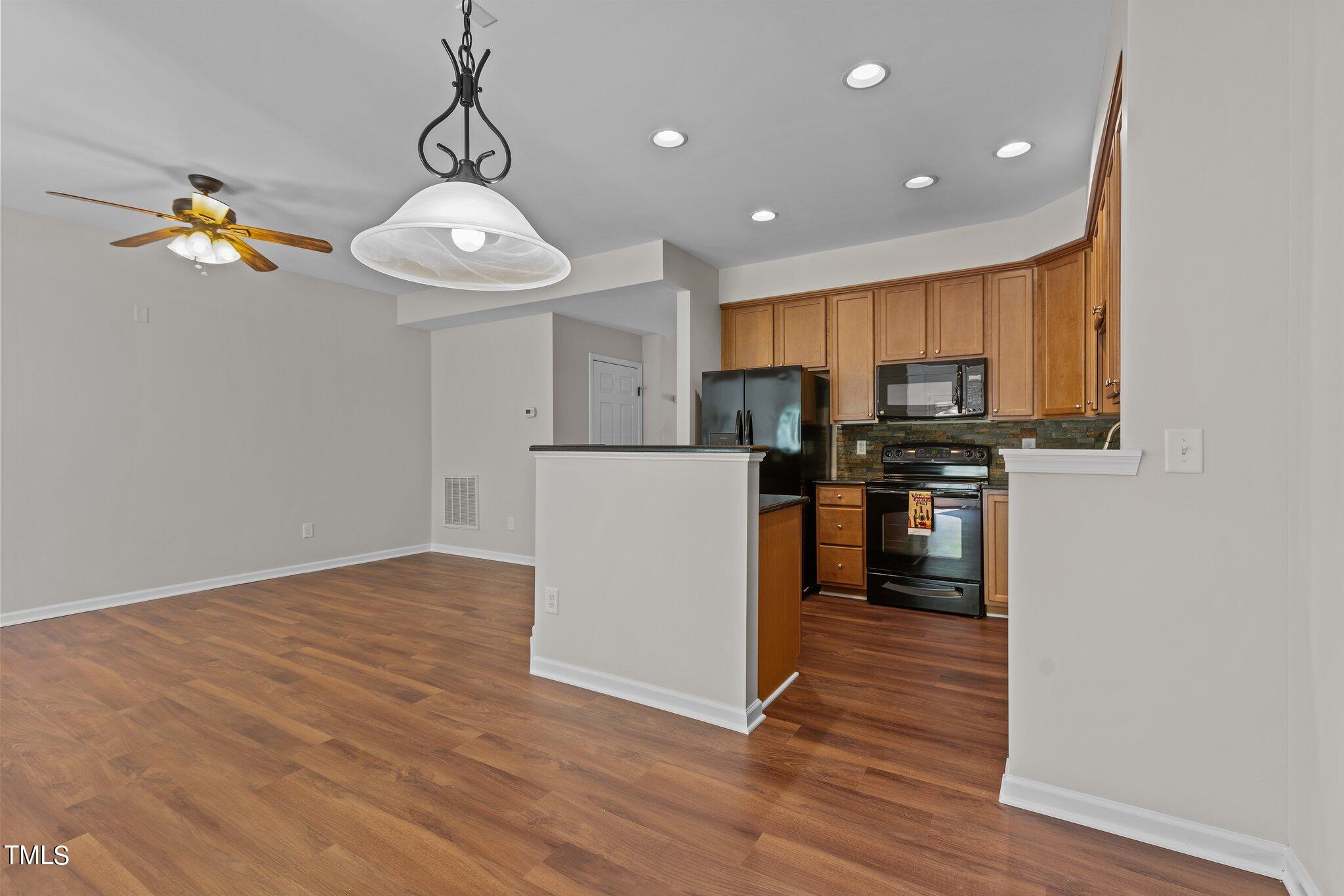 439 Panorama View Loop Cary, NC 27519 - Photo 18 of 42 a kitchen with stainless steel appliances a refrigerator sink and microwave