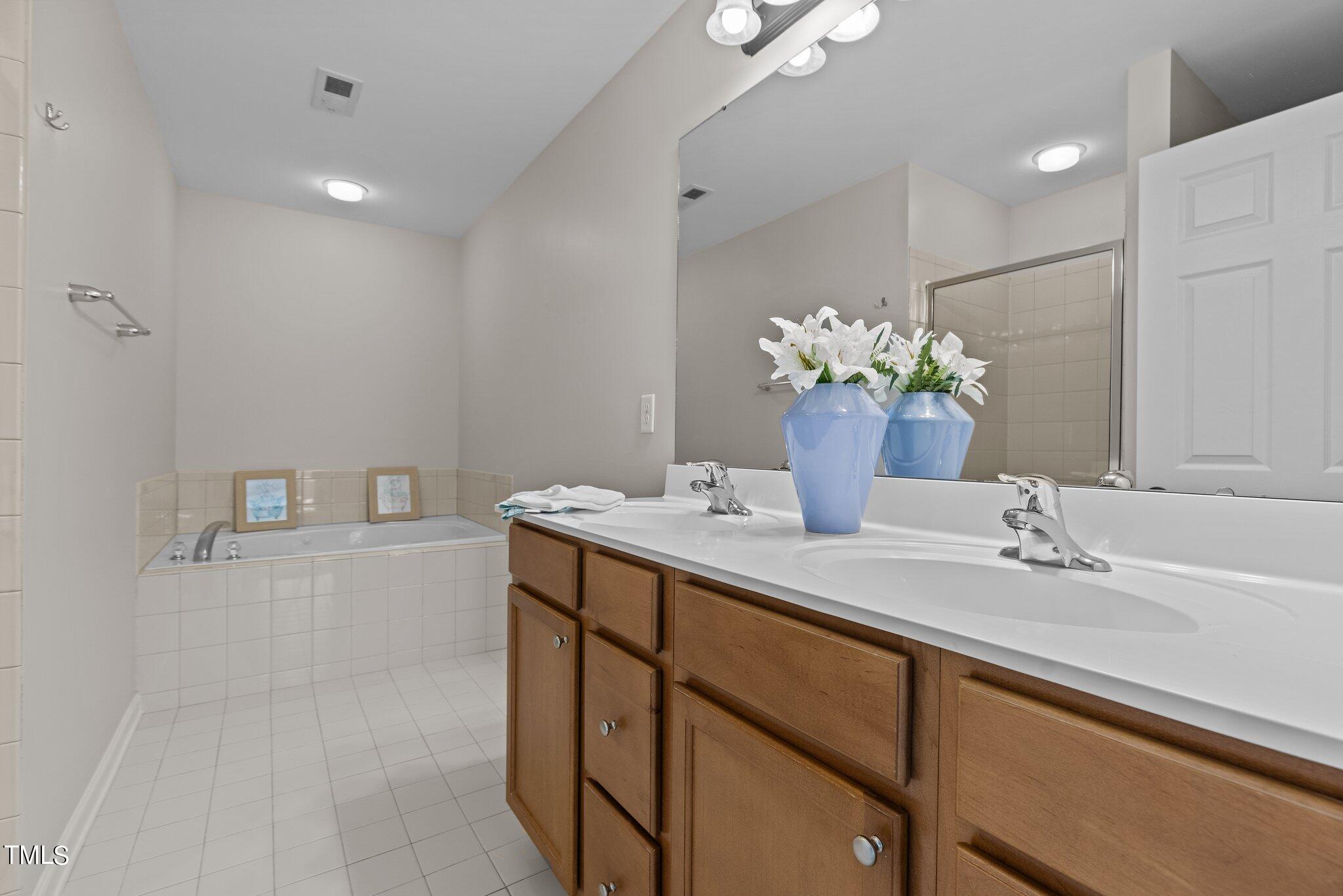 439 Panorama View Loop Cary, NC 27519 - Photo 30 of 42 a bathroom with a sink double vanity and a mirror