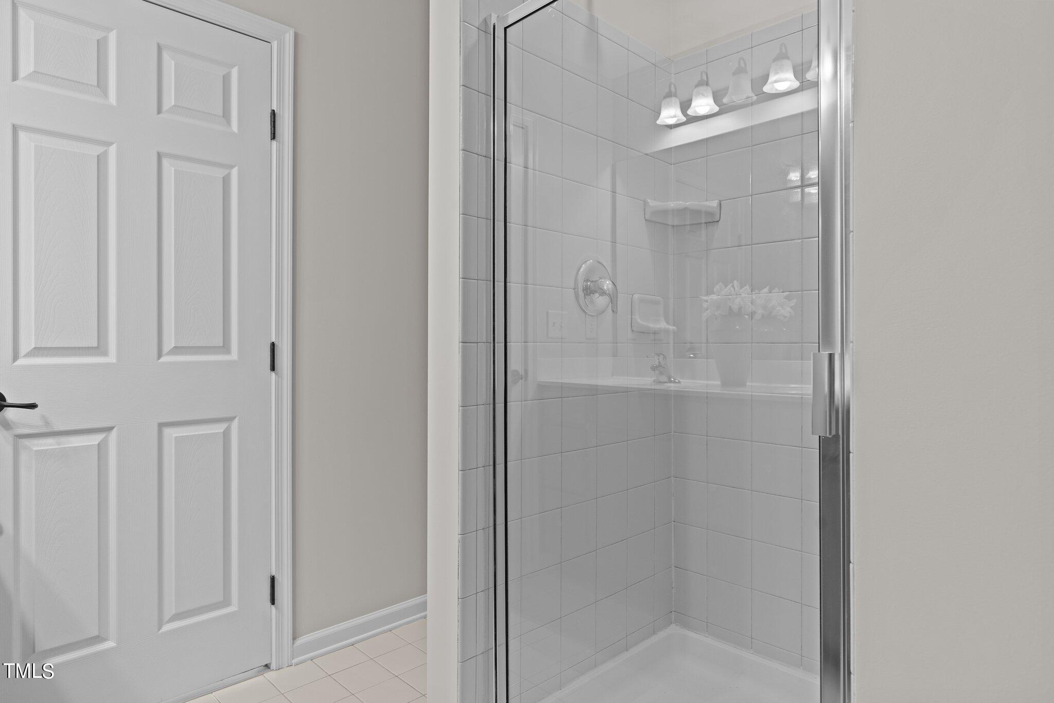 439 Panorama View Loop Cary, NC 27519 - Photo 32 of 42 a bathroom with a glass shower door