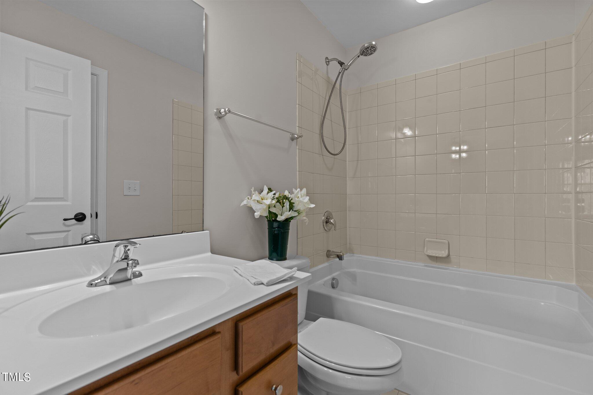 439 Panorama View Loop Cary, NC 27519 - Photo 37 of 42 a bathroom with a granite countertop sink a toilet and shower