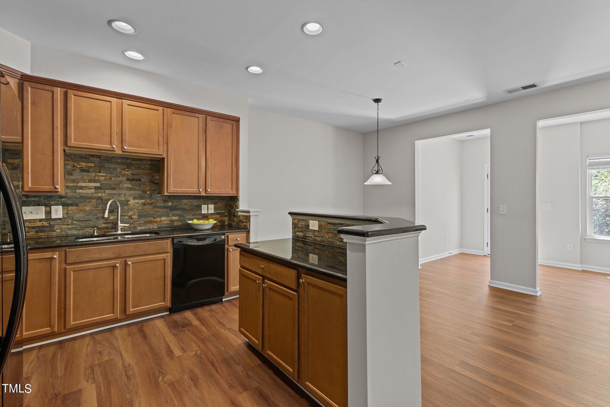 439 Panorama View Loop Cary, NC 27519 - Photo 6 of 42 a kitchen with stainless steel appliances granite countertop a stove a sink and a refrigerator