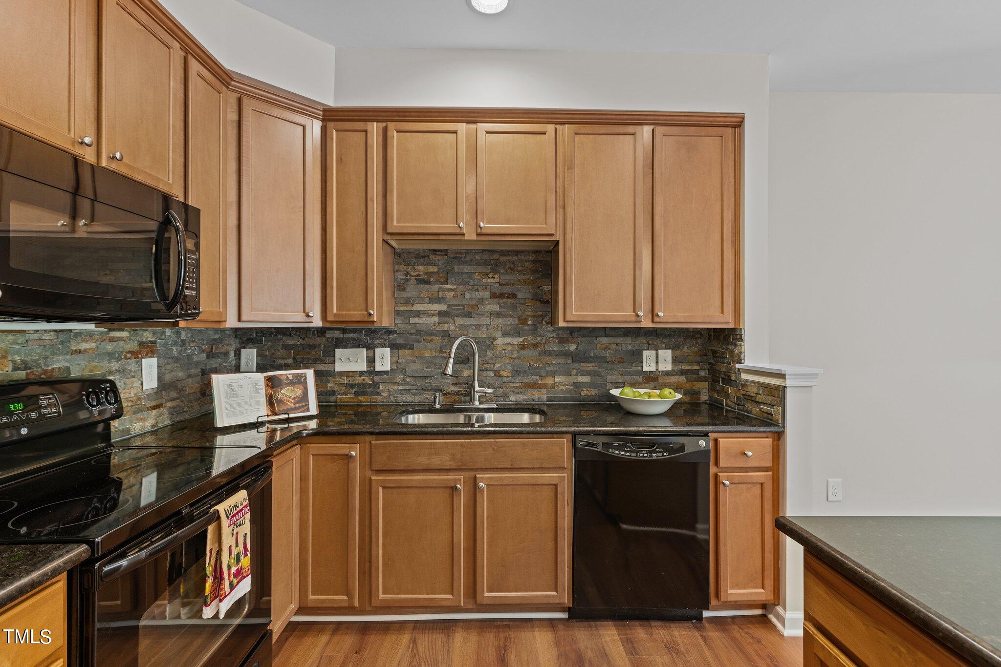 439 Panorama View Loop Cary, NC 27519 - Photo 7 of 42 a kitchen with stainless steel appliances granite countertop a stove a sink and a microwave