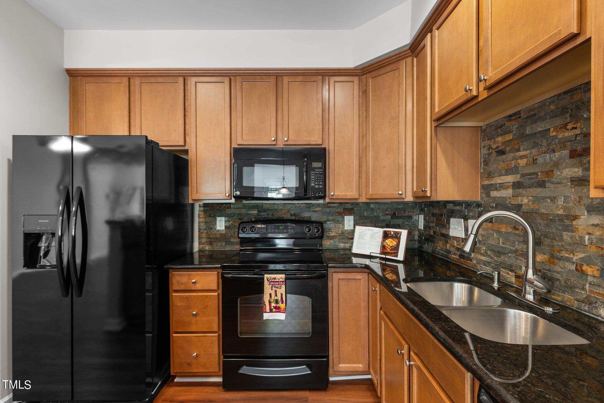 439 Panorama View Loop Cary, NC 27519 - Photo 9 of 42 a kitchen with granite countertop a refrigerator stove and sink
