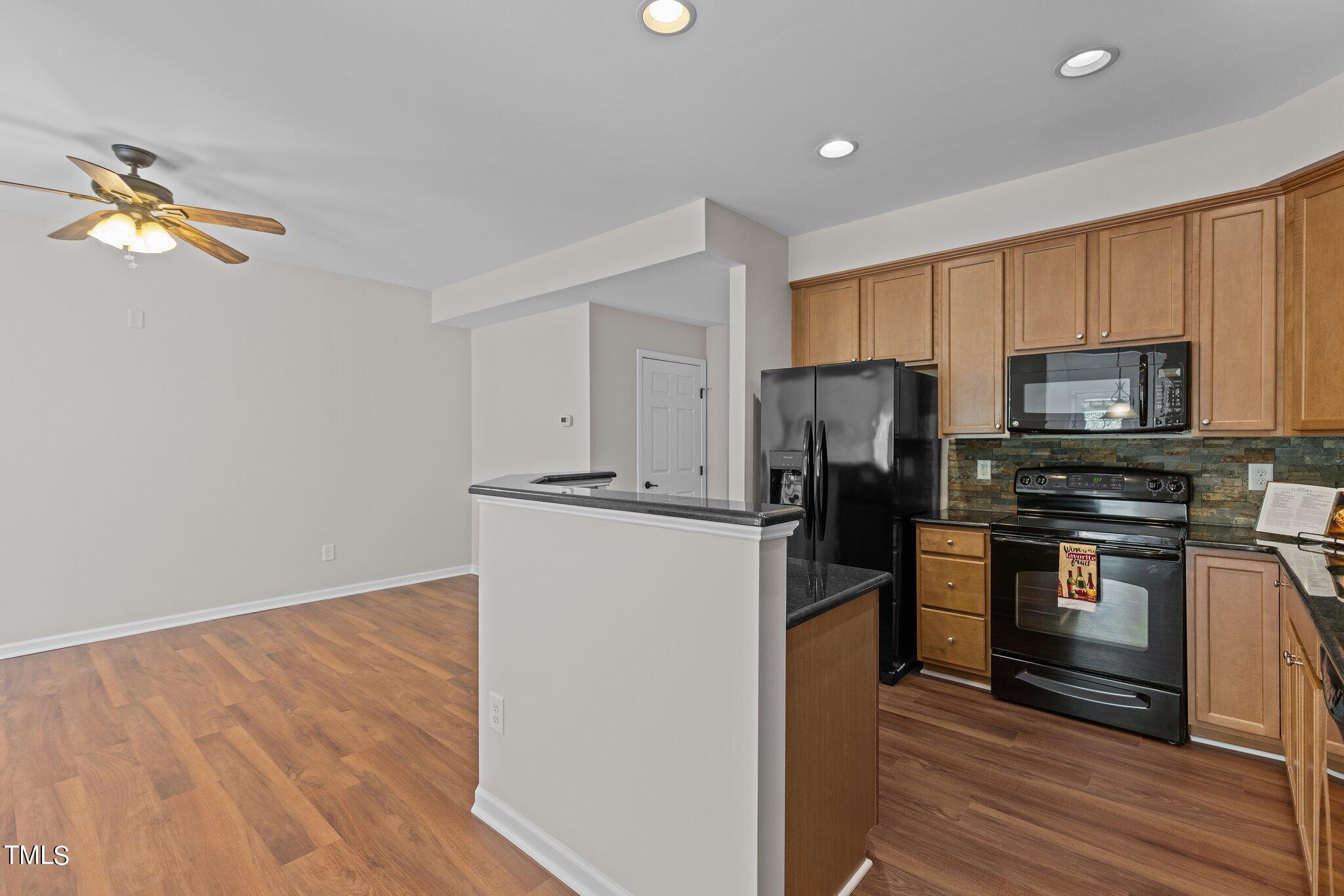 439 Panorama View Loop Cary, NC 27519 - Photo 10 of 42 a kitchen with a refrigerator cabinets and wooden floor