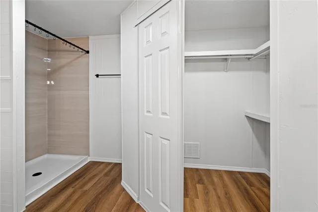a bathroom with a glass shower door and a sink