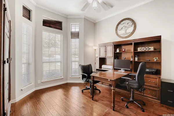a view of a workspace with furniture and a window