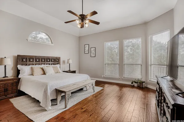a bedroom with a large bed and a large window
