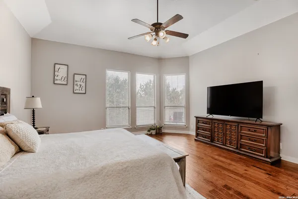 a bedroom with a bed and a flat screen television
