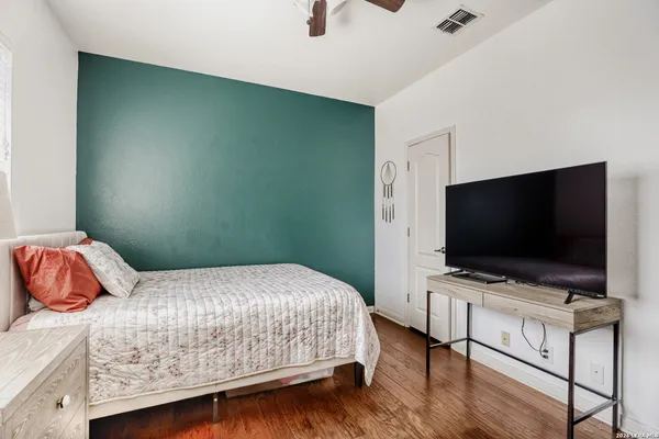 a bedroom with a bed and a flat screen tv