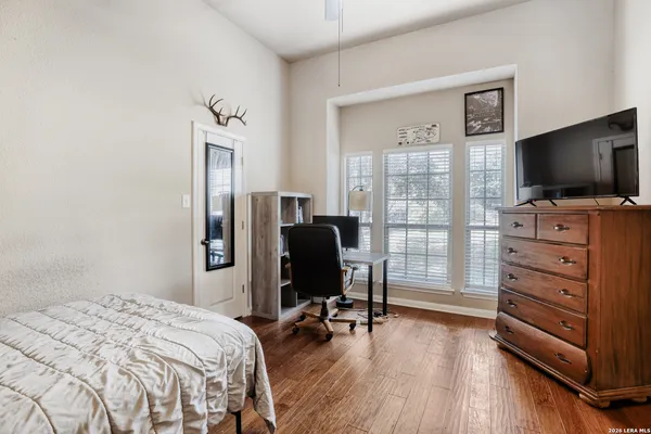 a bedroom with a bed and flat screen tv