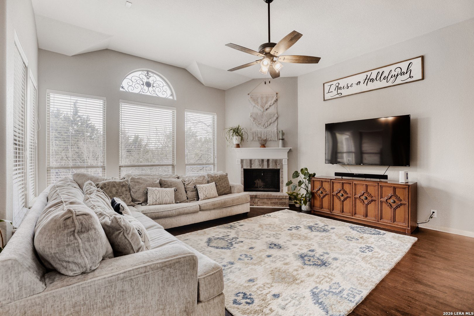8330 Magdalena Run Helotes, TX 78023 - Photo 4 of 24 a living room with furniture a flat screen tv and a large window