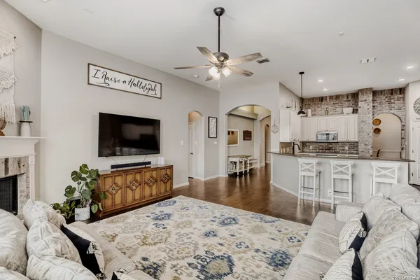 a living room with granite countertop furniture and a flat screen tv