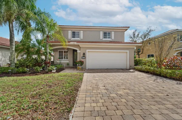 a front view of a house with a yard and a garage