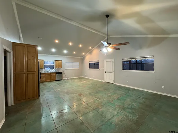 a view of a kitchen with a refrigerator and a ceiling fan