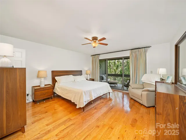 a spacious bedroom with a bed couch and a large window