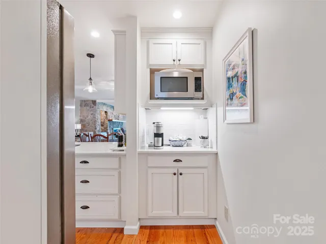 a kitchen with stainless steel appliances cabinets and a window
