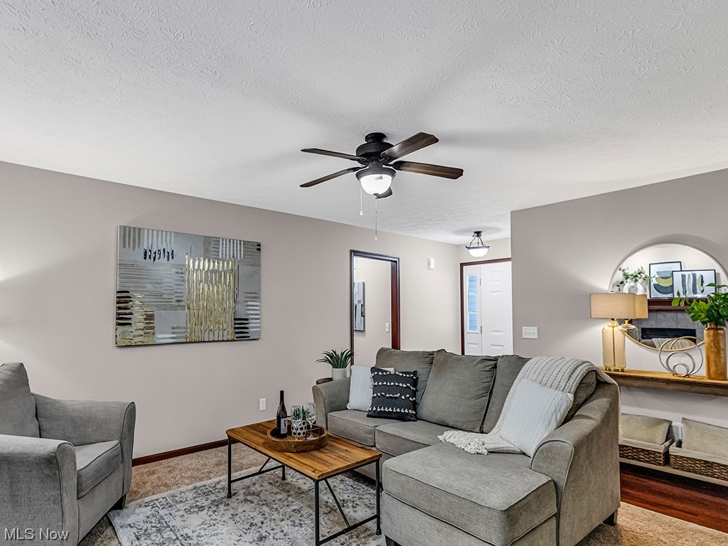 891 Susan Road Ravenna, OH 44266 - Photo 4 of 28 Living room with hardwood / wood-style floors, ceiling fan, and a textured ceiling