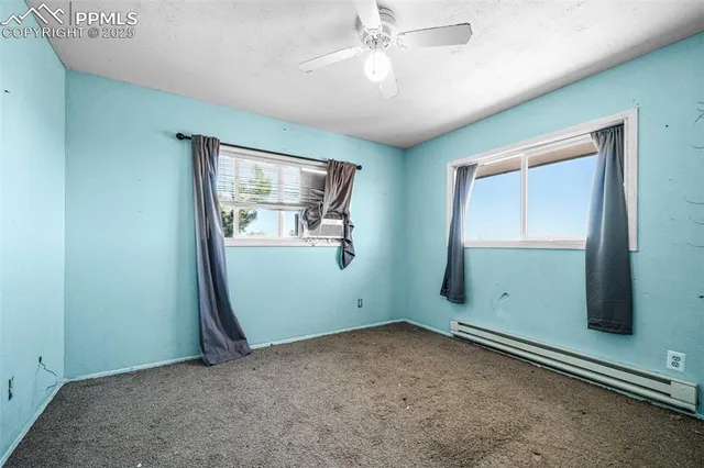 an empty room with windows and closet