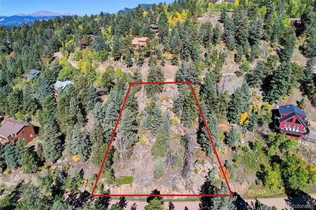 an aerial view of a houses with a yard