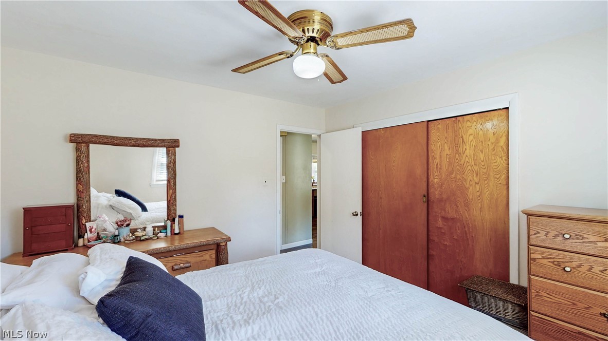 3659 Morrow Road Kent, OH 44240 - Photo 19 of 39 Bedroom featuring a brass-finish ceiling fan, wood-finish bi-fold closet doors, and light-toned wall paint