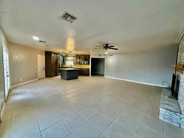 a view of a livingroom with furniture and a ceiling fan