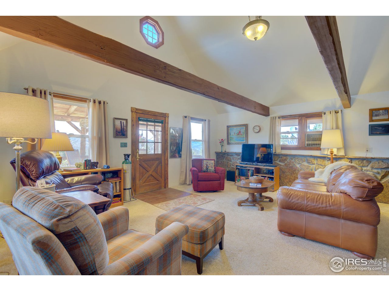 900 Spruce Drive Lyons, CO 80540 - Photo 11 of 40 a living room with furniture and a flat screen tv