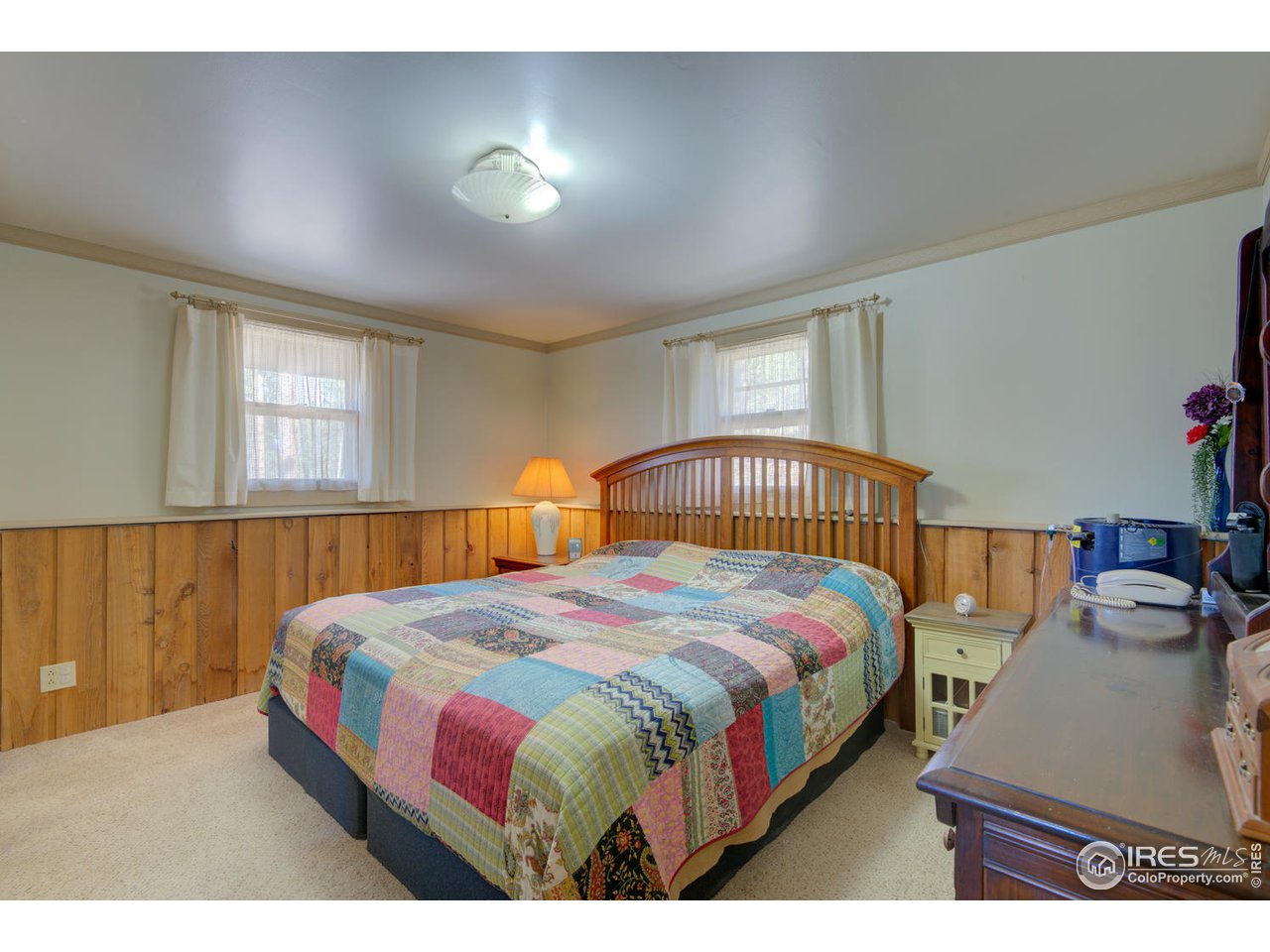 900 Spruce Drive Lyons, CO 80540 - Photo 12 of 40 a bedroom with a bed and window