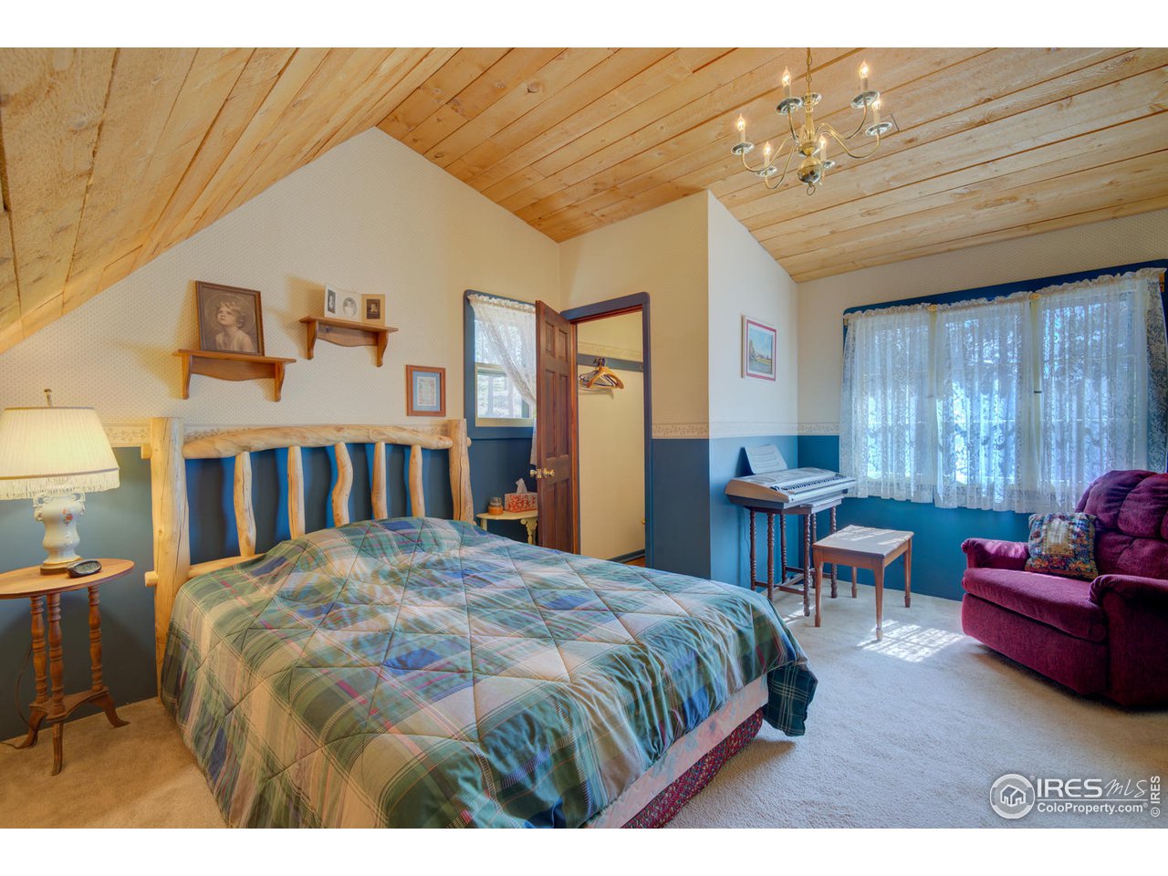 900 Spruce Drive Lyons, CO 80540 - Photo 13 of 40 a bedroom with a bed a table and chair