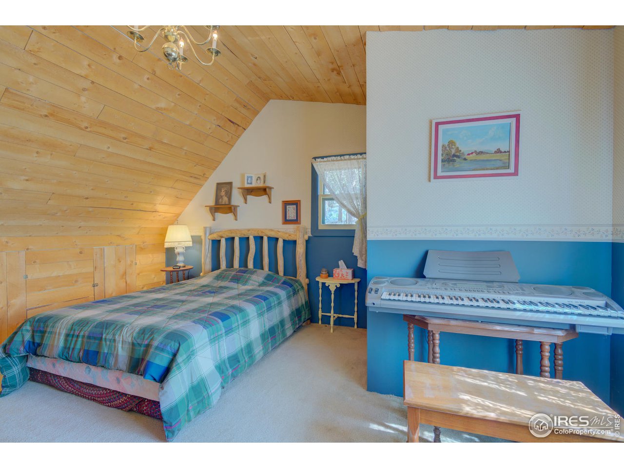 900 Spruce Drive Lyons, CO 80540 - Photo 14 of 40 a bedroom with a bed and a night stand