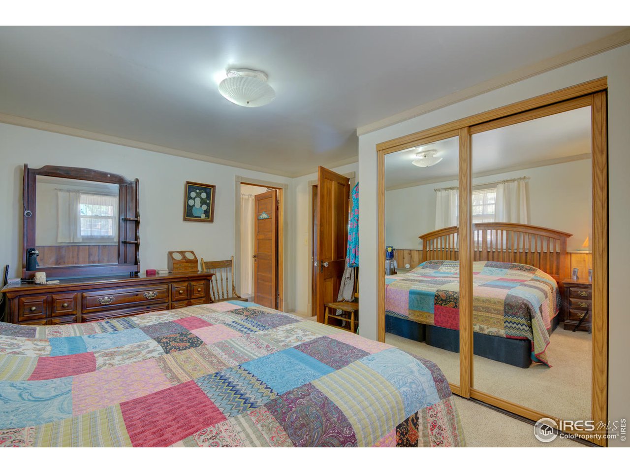 900 Spruce Drive Lyons, CO 80540 - Photo 15 of 40 a bedroom with a bed and large mirror