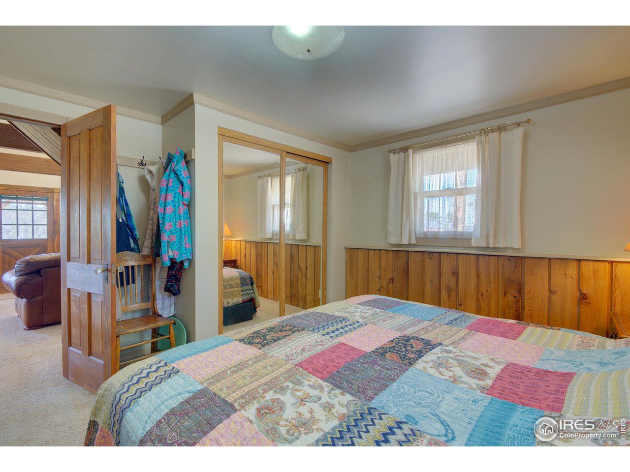 900 Spruce Drive Lyons, CO 80540 - Photo 16 of 40 a bedroom with a bed and a dresser