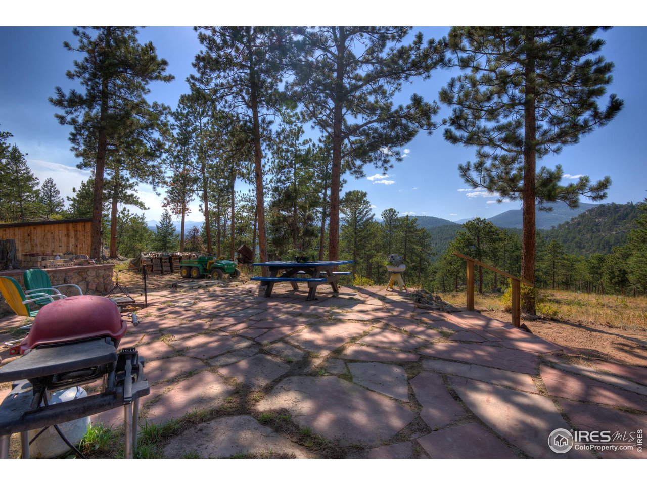 900 Spruce Drive Lyons, CO 80540 - Photo 25 of 40 a view of backyard with table and chairs and a fire pit
