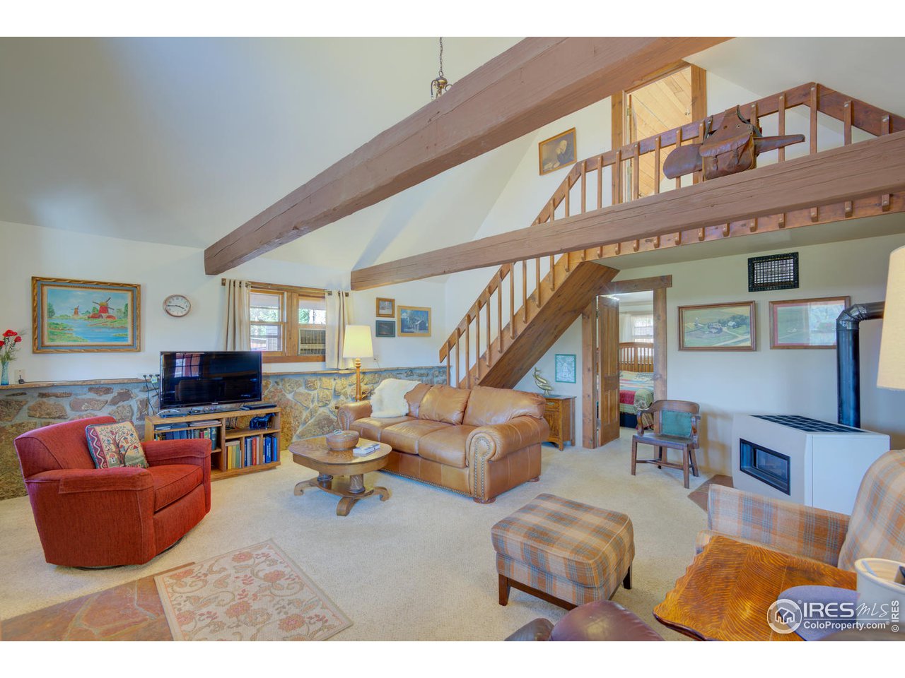 900 Spruce Drive Lyons, CO 80540 - Photo 9 of 40 a living room with furniture fireplace and a flat screen tv