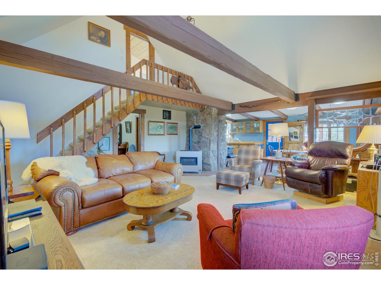 900 Spruce Drive Lyons, CO 80540 - Photo 10 of 40 a living room with furniture a window and a flat screen tv