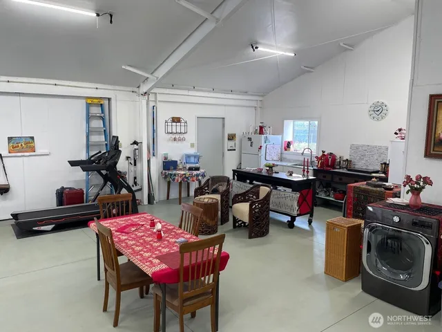 a living room with furniture a rug and gym equipment