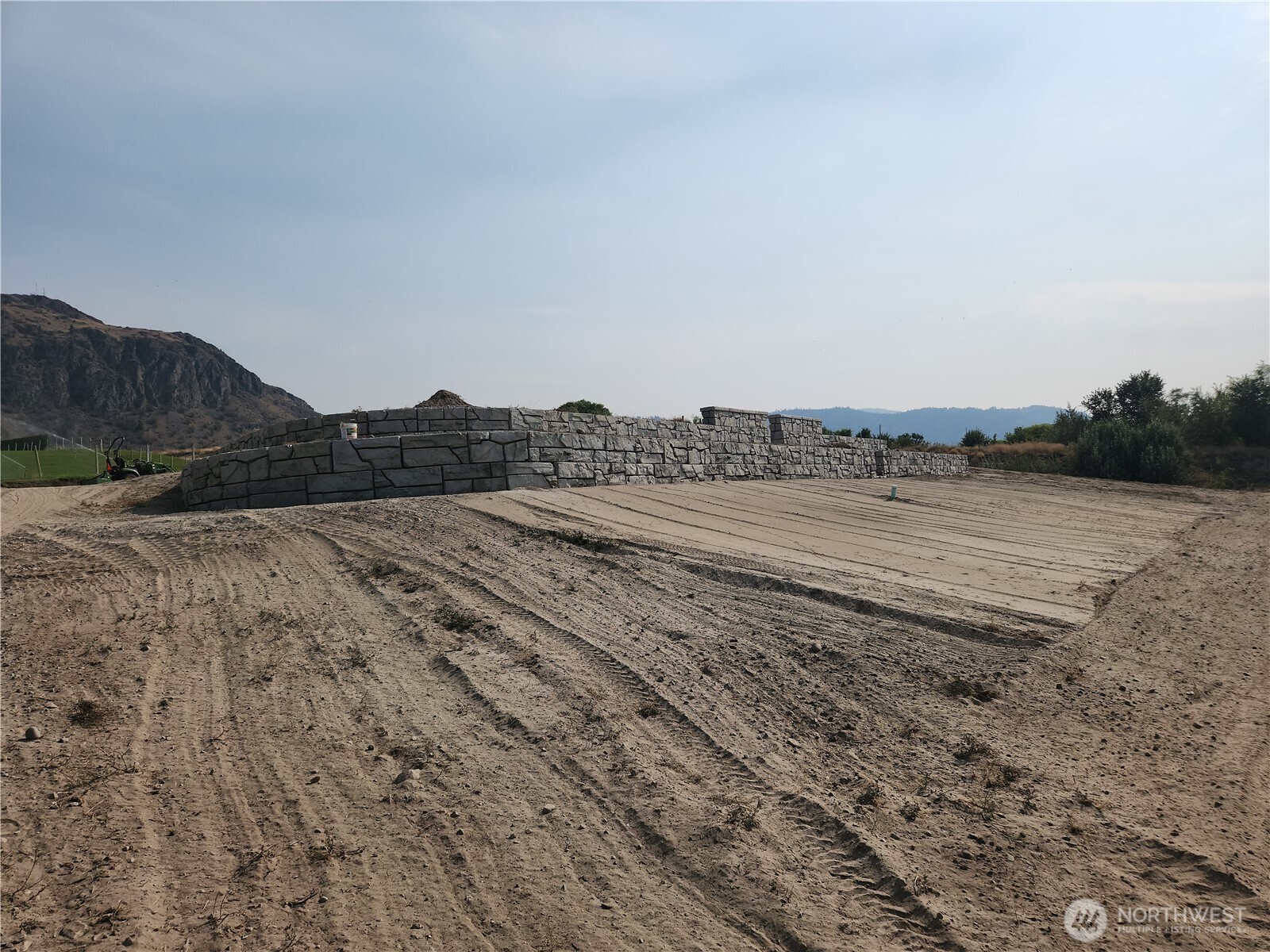 136 Eastlake Road Oroville, WA 98844 - Photo 18 of 20 a view of a dry field with trees in the background