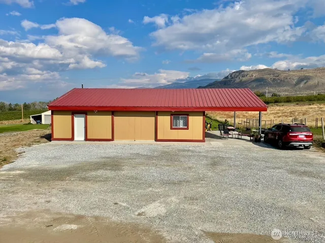 a red car parked in front of a house