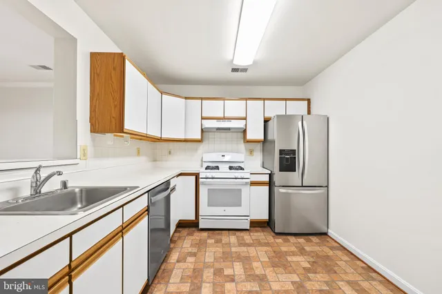 a kitchen with a sink a refrigerator and a sink