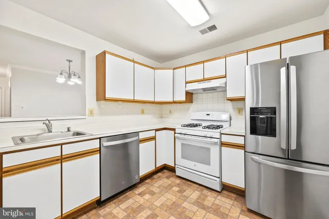 a kitchen with a sink stove and refrigerator