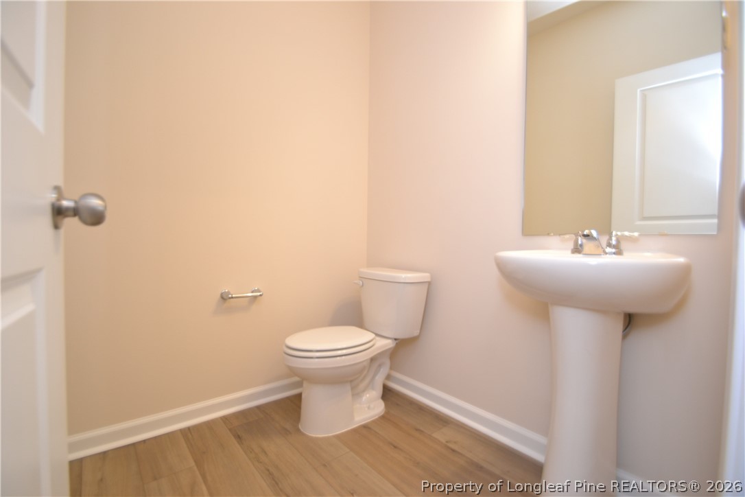 5703 Preveza Place Raleigh, NC 27603 - Photo 11 of 33 a bathroom with a sink toilet and a mirror
