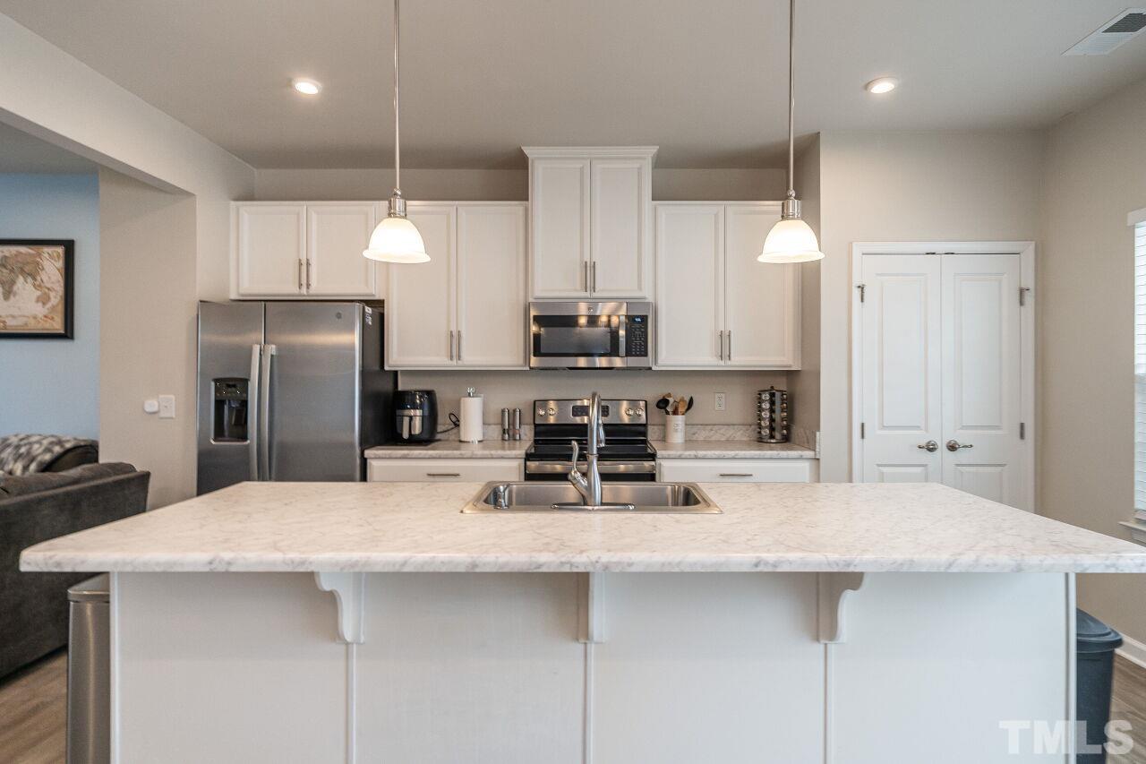 8701 Red Canyon Way Raleigh, NC 27616 - Photo 18 of 28 a kitchen with stainless steel appliances a sink stove and refrigerator