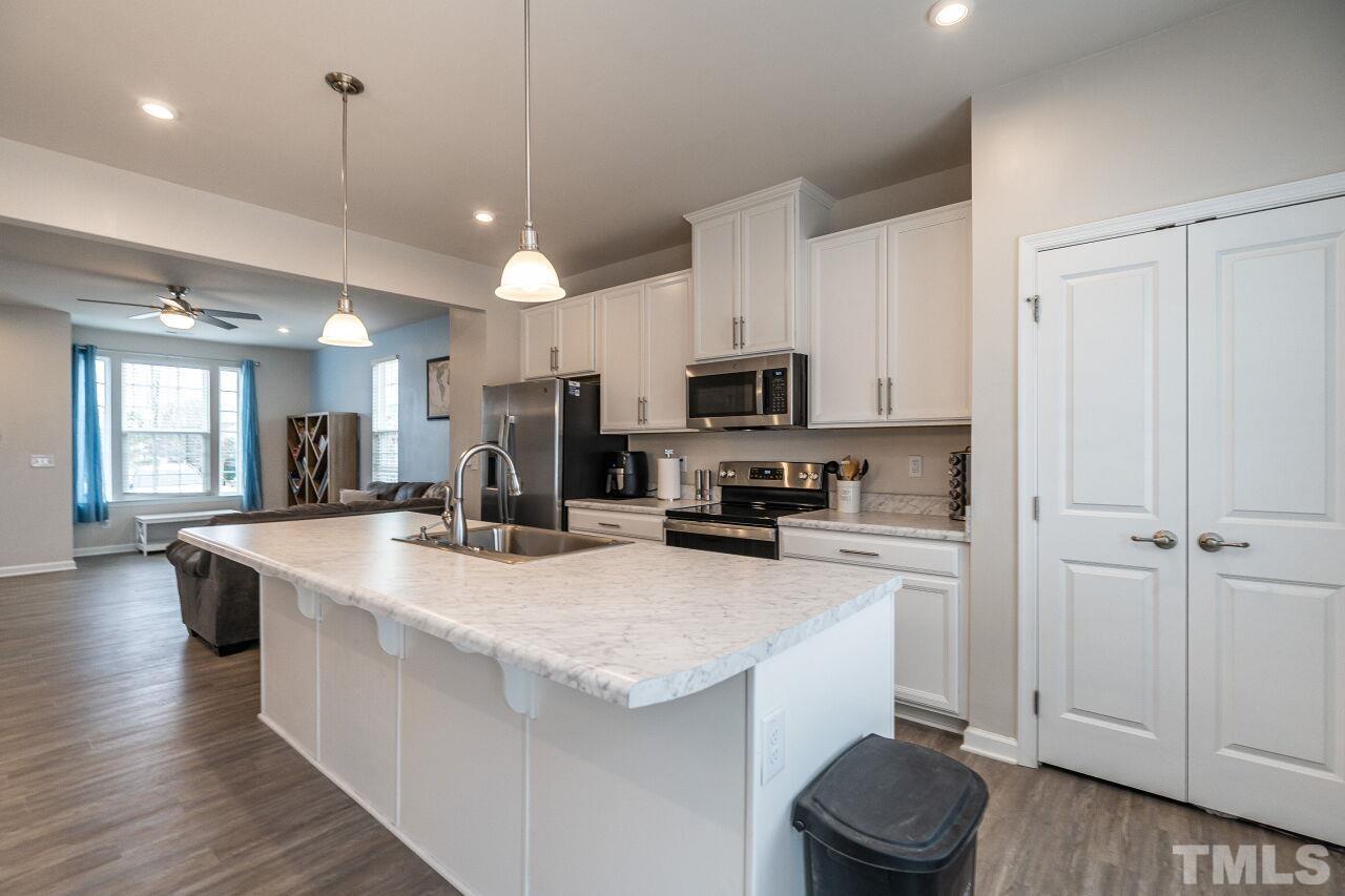 8701 Red Canyon Way Raleigh, NC 27616 - Photo 20 of 28 a kitchen with sink a microwave and wooden floor