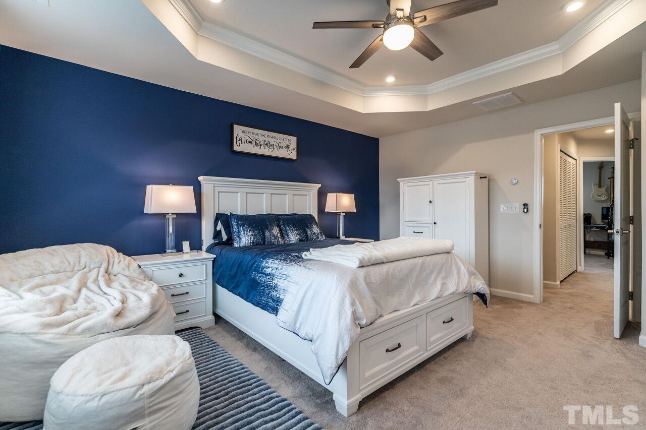 8701 Red Canyon Way Raleigh, NC 27616 - Photo 25 of 28 a bed room with a bed and a chandelier