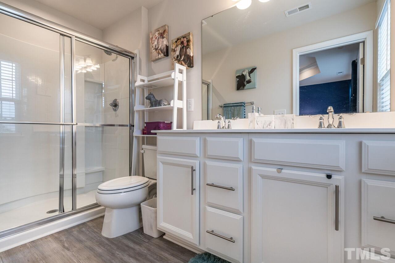 8701 Red Canyon Way Raleigh, NC 27616 - Photo 26 of 28 a bathroom with a sink toilet a mirror and shower